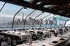 Enjoy a fancy dinner with an ocean view from the glass-enclosed deck