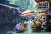 Board a wooden boat and pass by many floating stalls loaded with colorful foods, fruits, and souvenirs