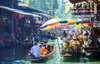 Paddle your way through the bustling Damnoen Saduak Floating Market