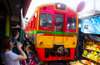 Watch the incoming train pass through the market at Maeklong Railway Market