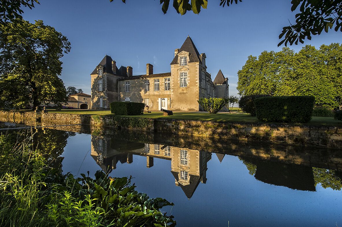 Chateau d'Issan reflected in calm water
