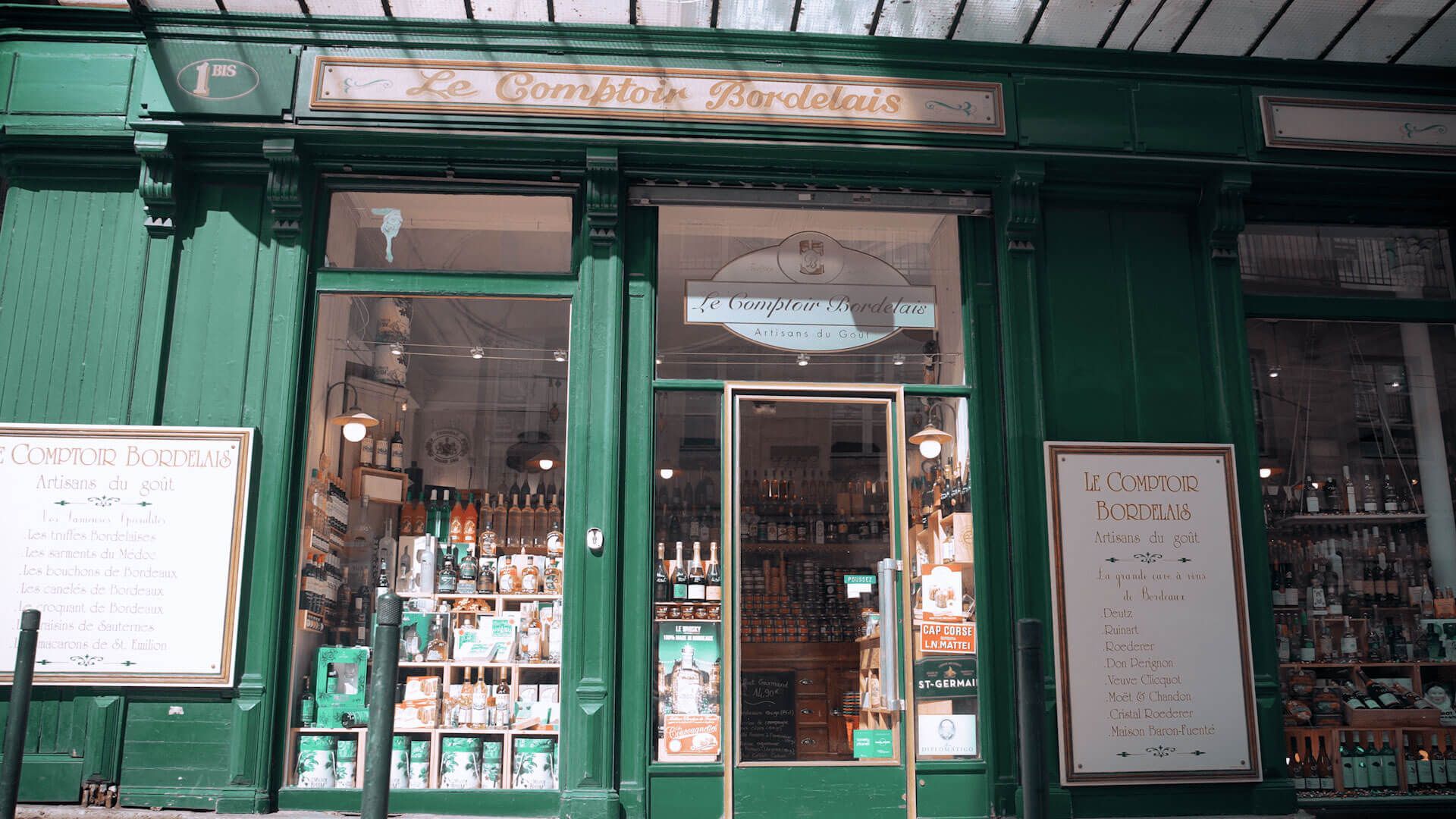 Storefront with green facade and bottles