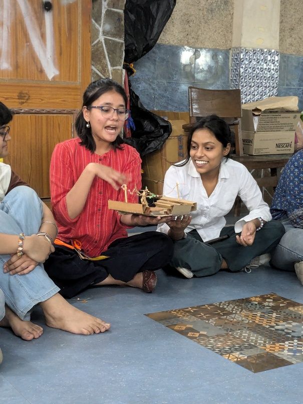 A group building college chaupal using junk