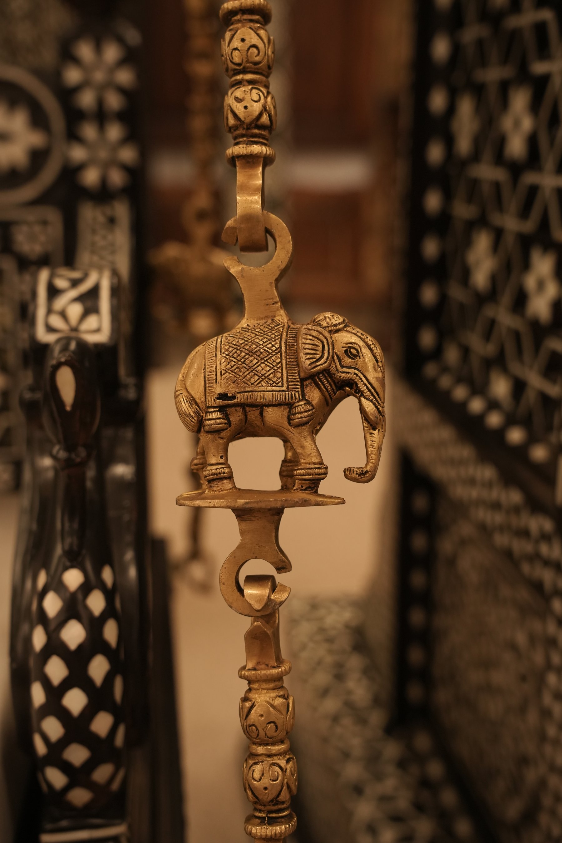A handcrafted solid teakwood Indian jhula adorned with exquisite mother-of-pearl inlay work, featuring intricate carvings and timeless traditional elegance.