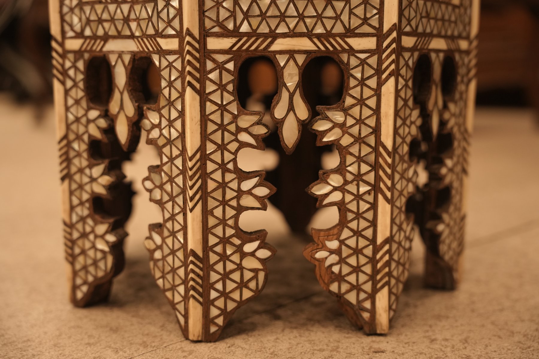 This handmade Egyptian or Moroccan style side table features intricate geometric mother of pearl and bone inlay design.