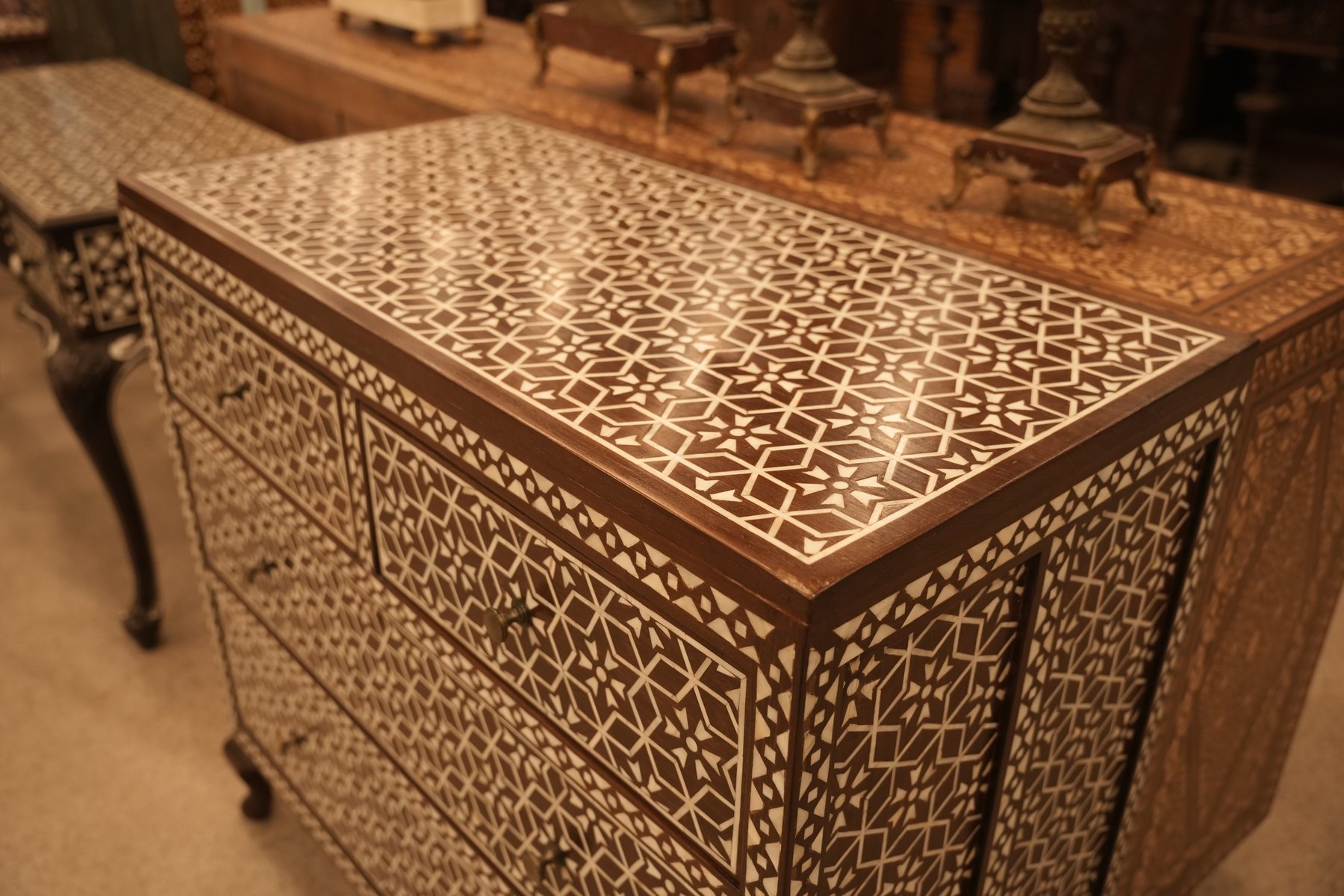 Antique handmade chest of drawers adorned with intricate mother-of-pearl inlay work, featuring elegant geometric patterns and fine craftsmanship that reflect timeless beauty and heritage.