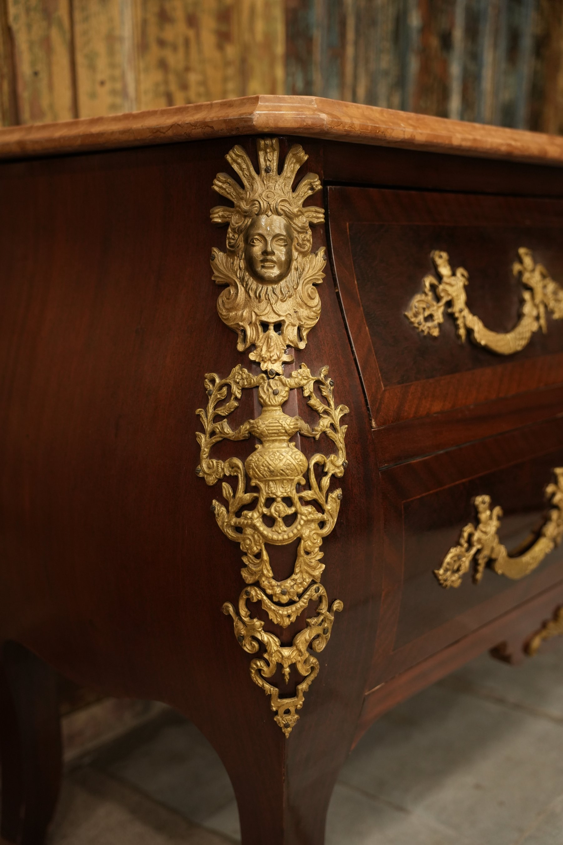 Louis XV-style bombe commode with marble top, two drawers, and intricate brass detailing - a refined expression of French-inspired elegance.