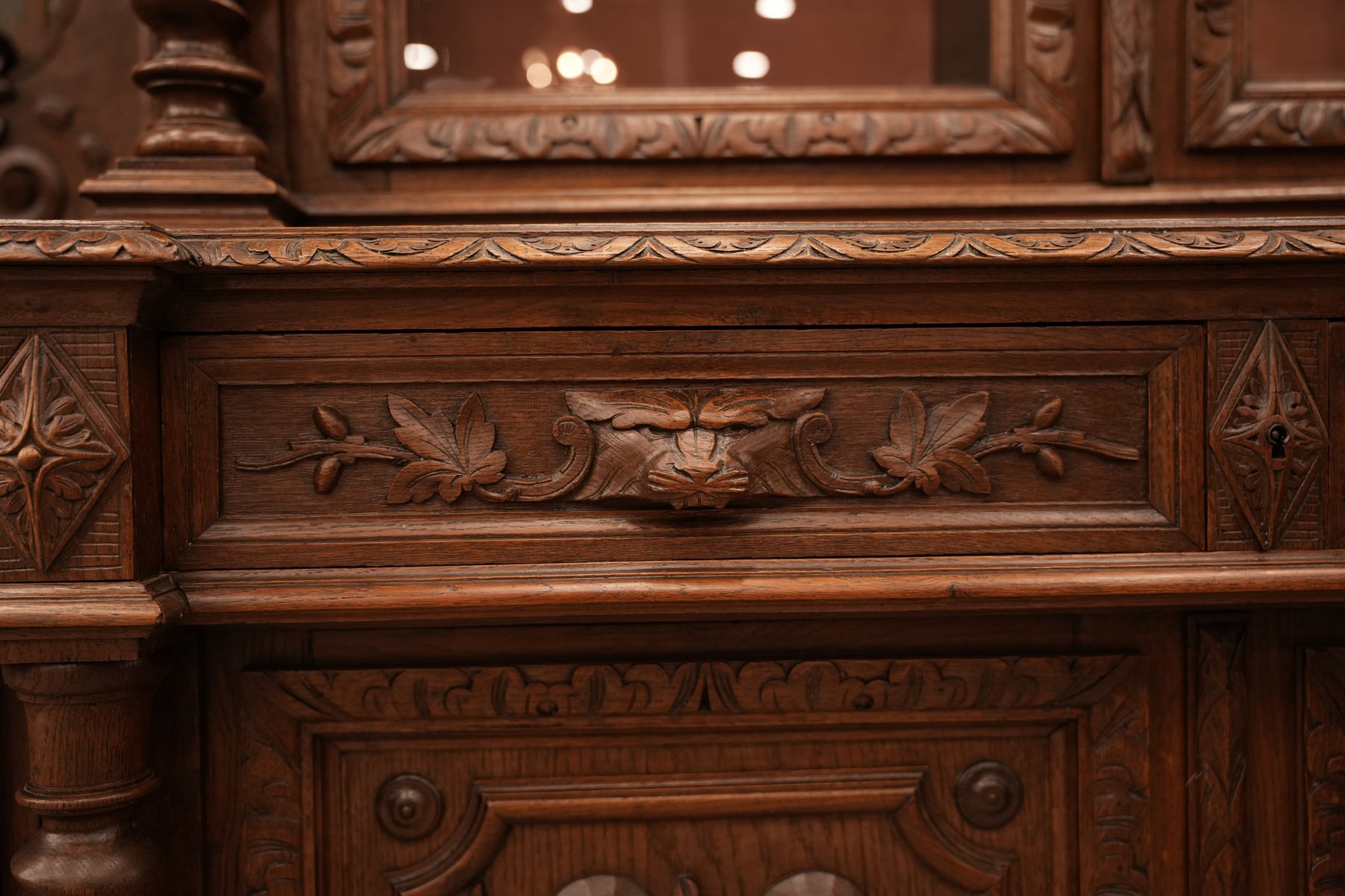Antique French Renaissance Revival oak cabinet with exquisite bird and foliage carvings, showcasing timeless craftsmanship and historic elegance.