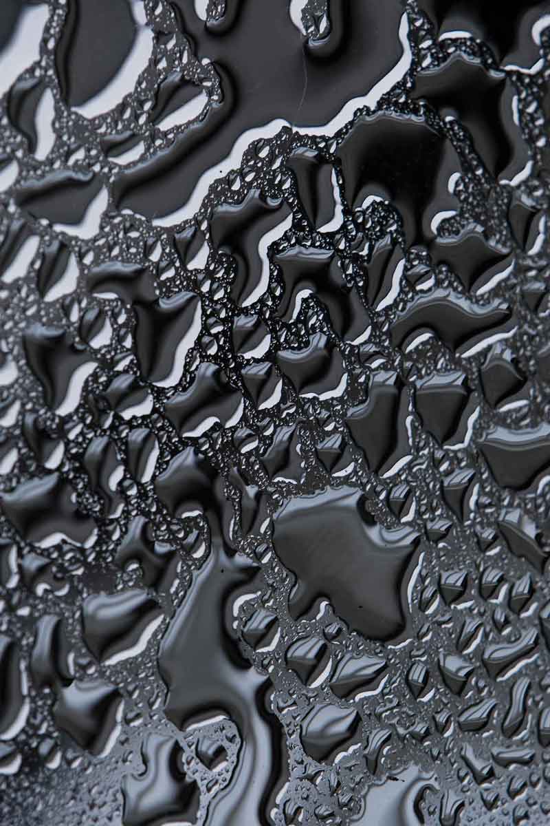 Close-up of the chrome fluid art swirl pattern on the liquid metal door sticker