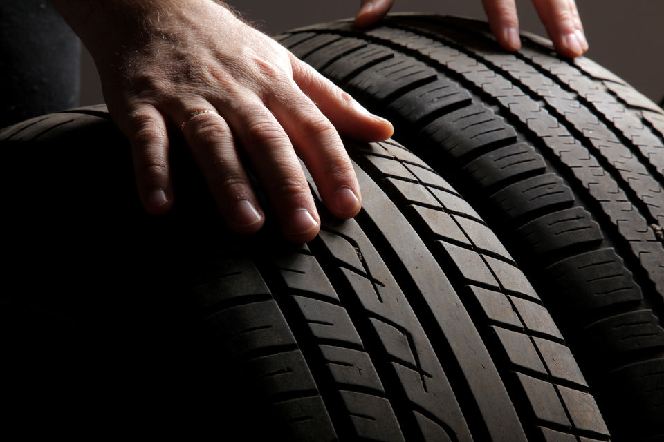 Hand checking tread of tyre
