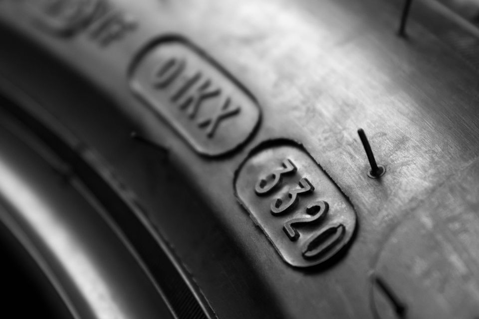 A close-up view of a tyre date stamp imprinted on the tyre sidewall