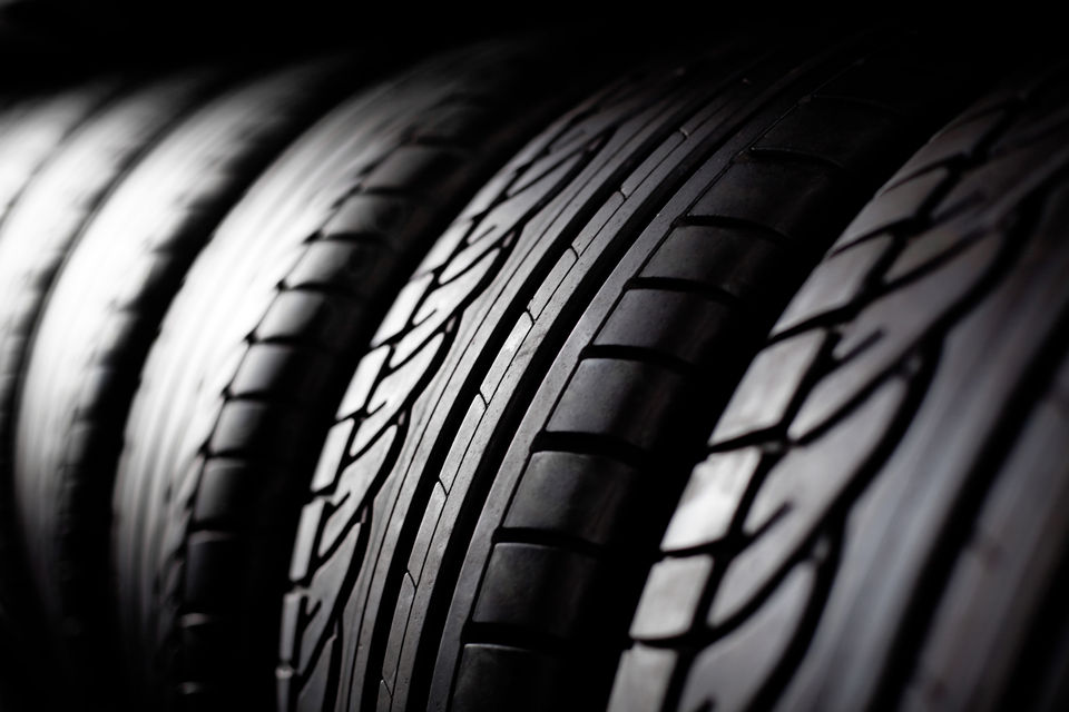 Brand new tyres neatly stored in a warehouse