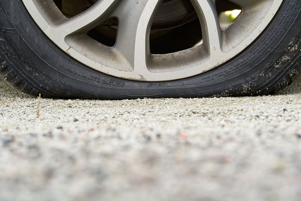 A flat tyre after a puncture or loss of air pressure