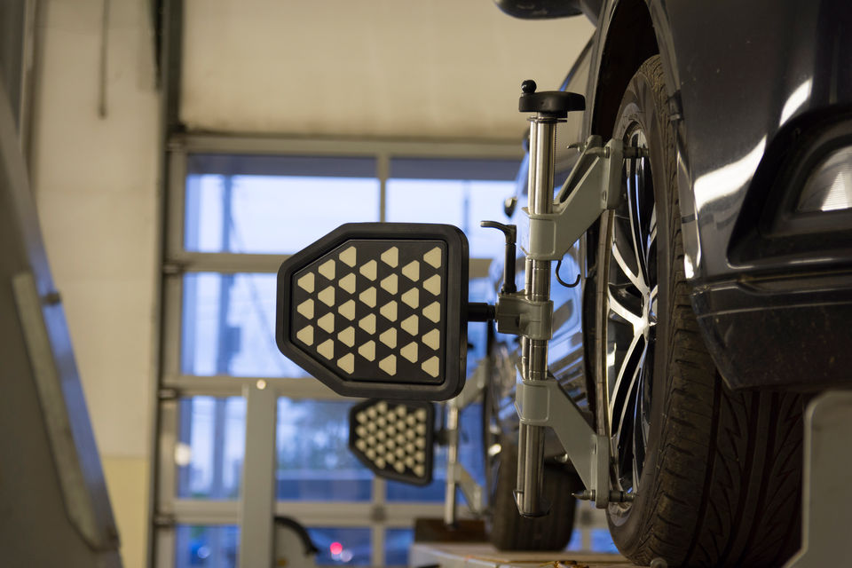 Car undergoing wheel alignment service