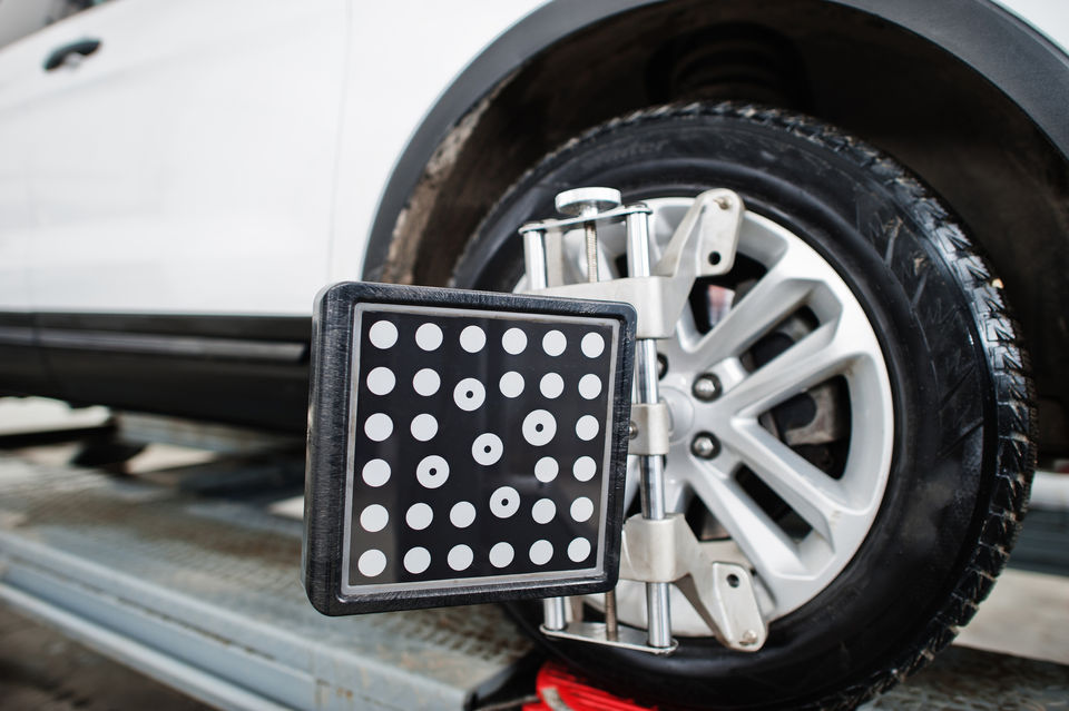 Car placed on a stand for wheel alignment process