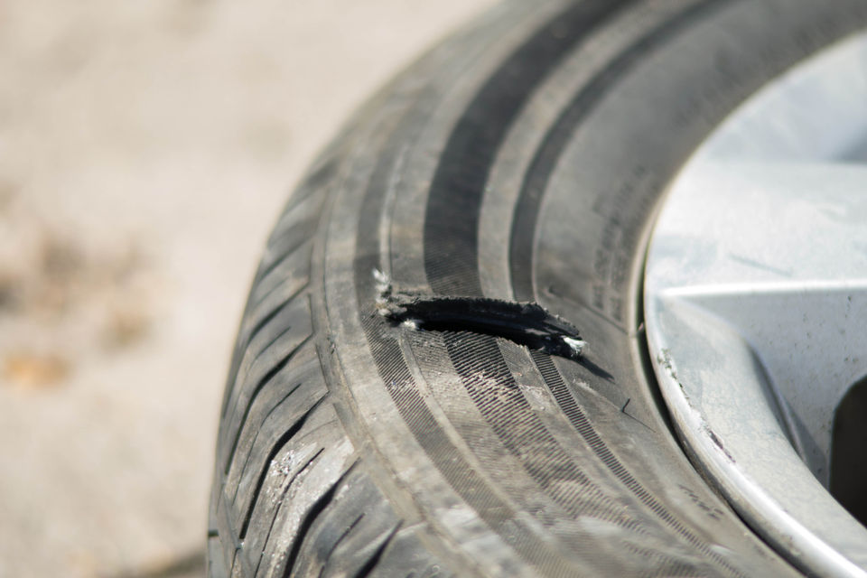 Close-up view of a defective tyre emphasizing visible signs of damage