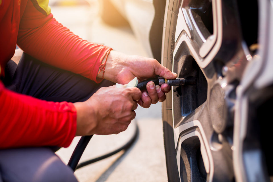 Technician inflating tyres with nitrogen