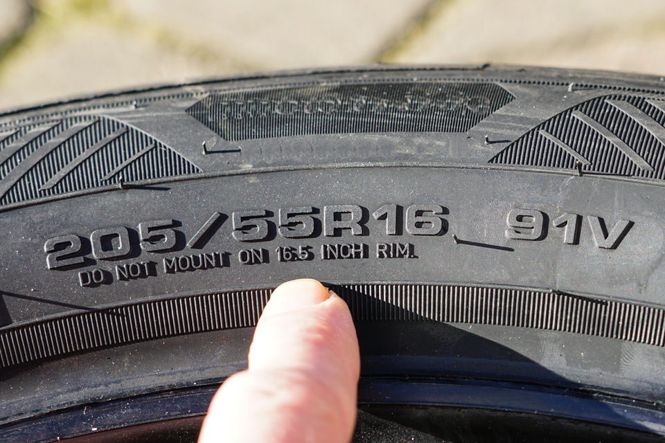 Tyre markings with a letter R signifying a radial tyre