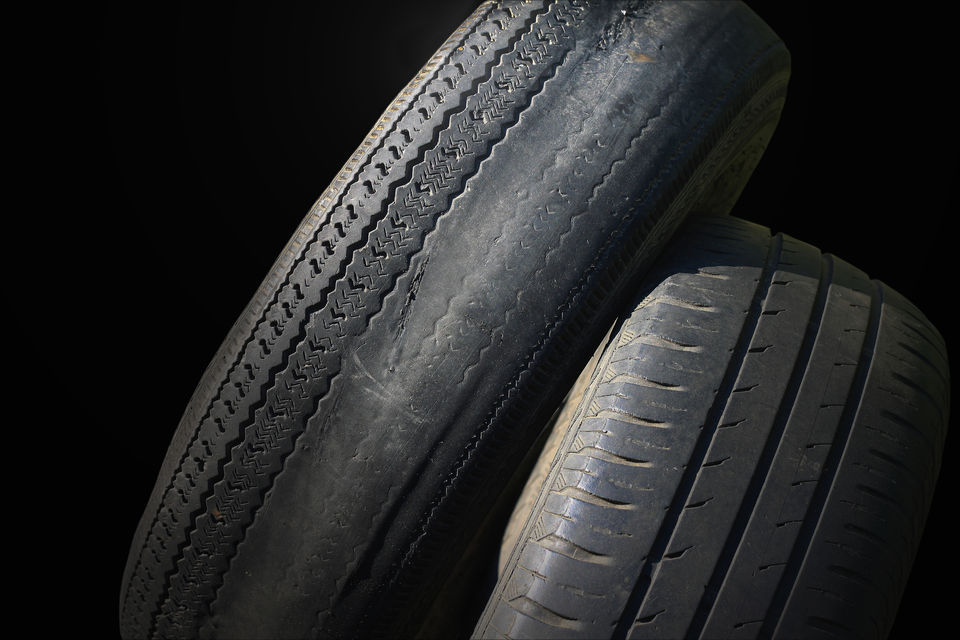 Car tyres showing signs of wear on the outside edge