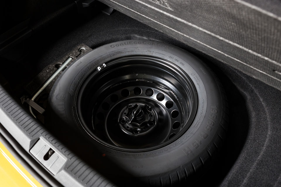 Spare tyre securely stored in the trunk of a car
