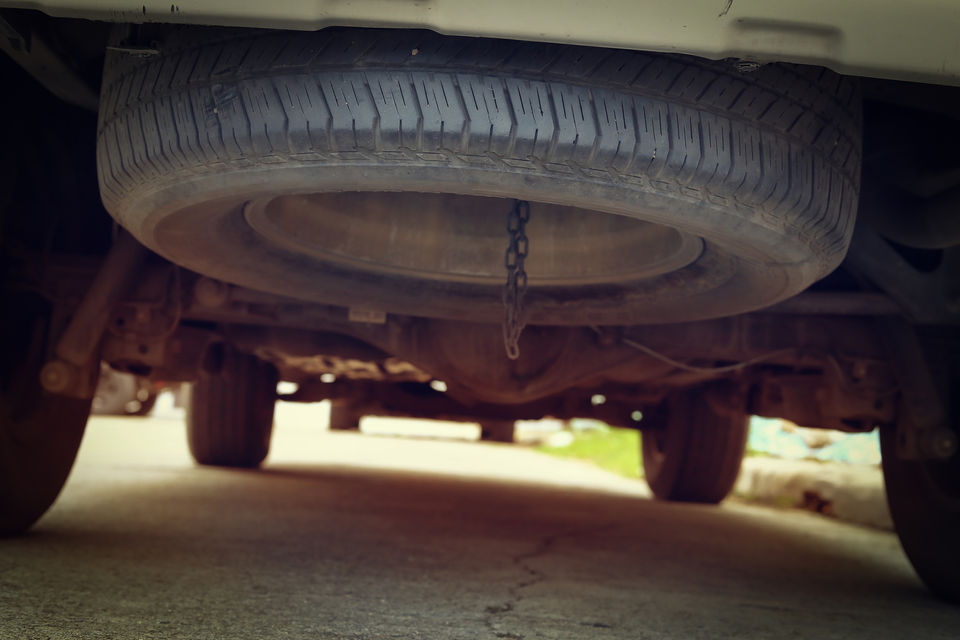 Spare tyre placed at the bottom of a car