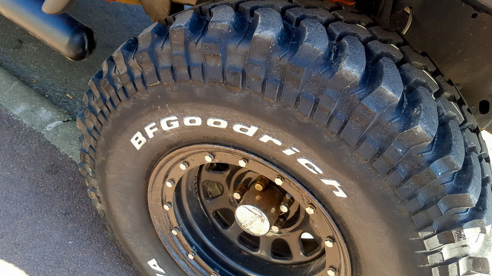 An off-road tyre with white lettering on a car