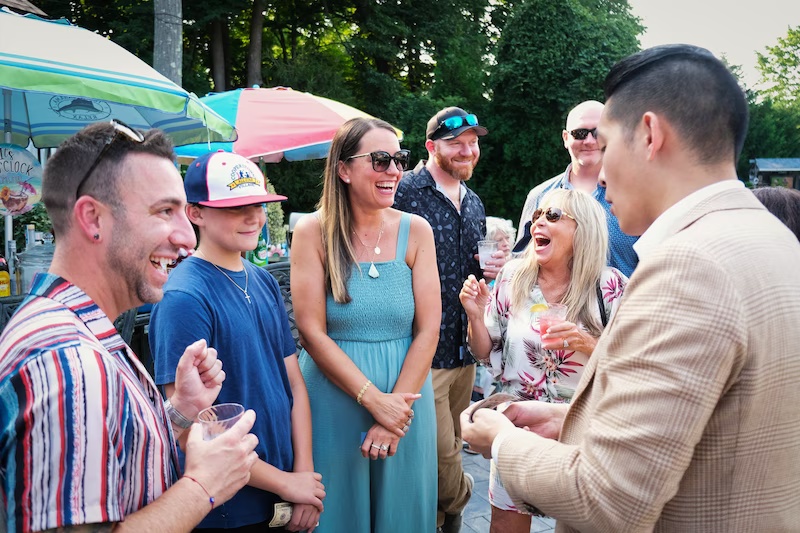 Guests watching Allen He perform at a private party