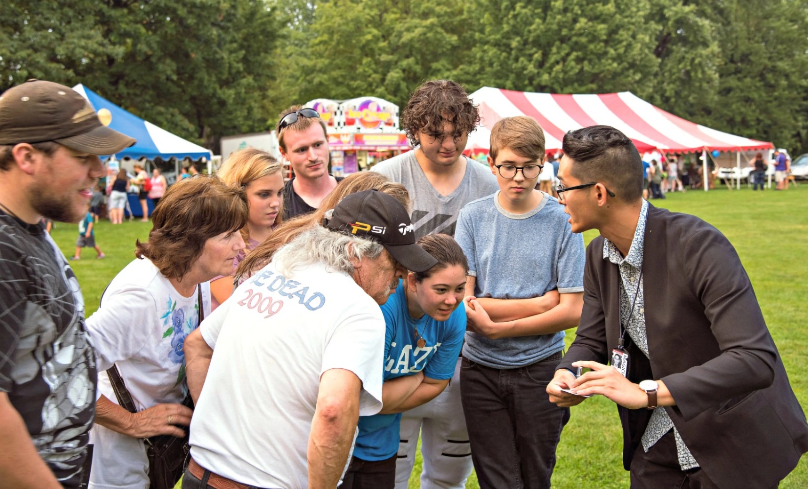 Professional magician Allen performing in a party event in Binghamton's Spiedie Festival.