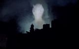 Projection of an image of an alien's head in the sky over London