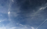 Wake turbulence trail that passes through the translucent haze of the cloud, forming the "empty" area and creates the illusion of a black band.

Excerpt: 1/533 sec

F-number: 2.2

ISO: 32

Flash: no flash
Translated by «Yandex.Translator»