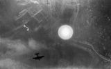 A flashbulb exploded over La Spezia during an air raid on the night of April 13-14, 1943. It illuminated the city's dockyard and the battleship (marked with the letter "A") standing at the parking lot. The silhouette of one of the attacking bombers is visible Avro Lancaster.