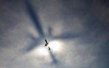 The shadow of an airplane is projected through a layer of fog, Logan Airport, Boston.