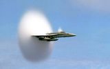 FA-18. You can see a cloud of condensation formed as a result of local pressure changes (the Effect of the Prandtl - Glauert). Often, such a picture was erroneously perceived as "breaking the sound barrier".
Translated by «Yandex.Translator»