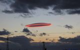 Lenticular (lenticular) clouds.

Formed between the two layers of air do not move, no matter what. Appear behind the mountain peaks.

The altitude of 15-20 km
Translated by «Yandex.Translator»