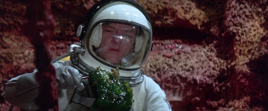 Astronaut holds green slime