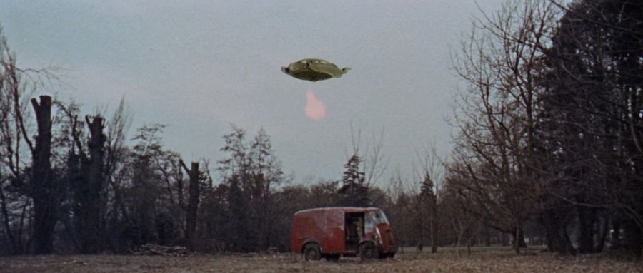 A flying Dalek ship shoots at a car