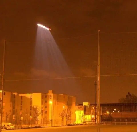 Helicopters monitor possible riots or protests after the 2007 presidential election in Lille, France. The helicopter is equipped with a powerful searchlight that draws a line when moving due to the high exposure.