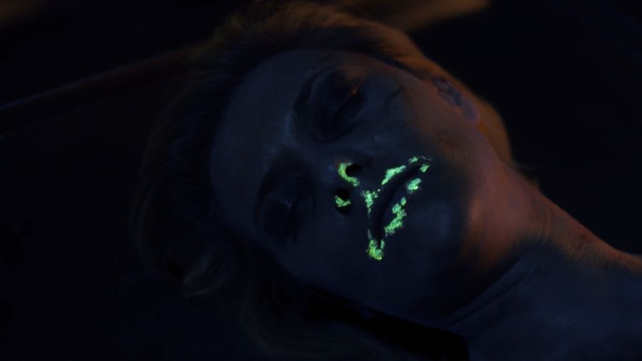 Glow-in-the-dark substance on the dead woman's face