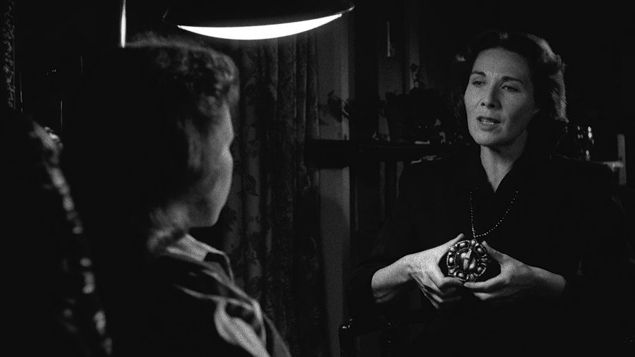 A schoolteacher hypnotizes a girl with an amulet brought from the Carpathians