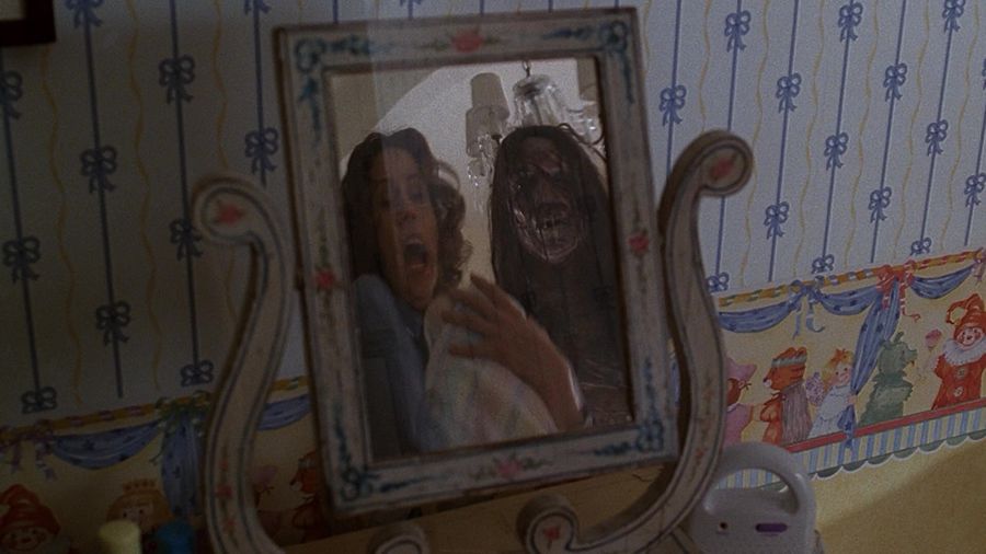 The reflection of the monster in the glass next to the female werewolf