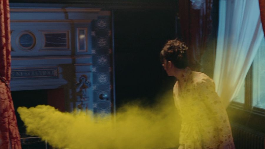A ghost in the form of yellow smoke flies into the fireplace