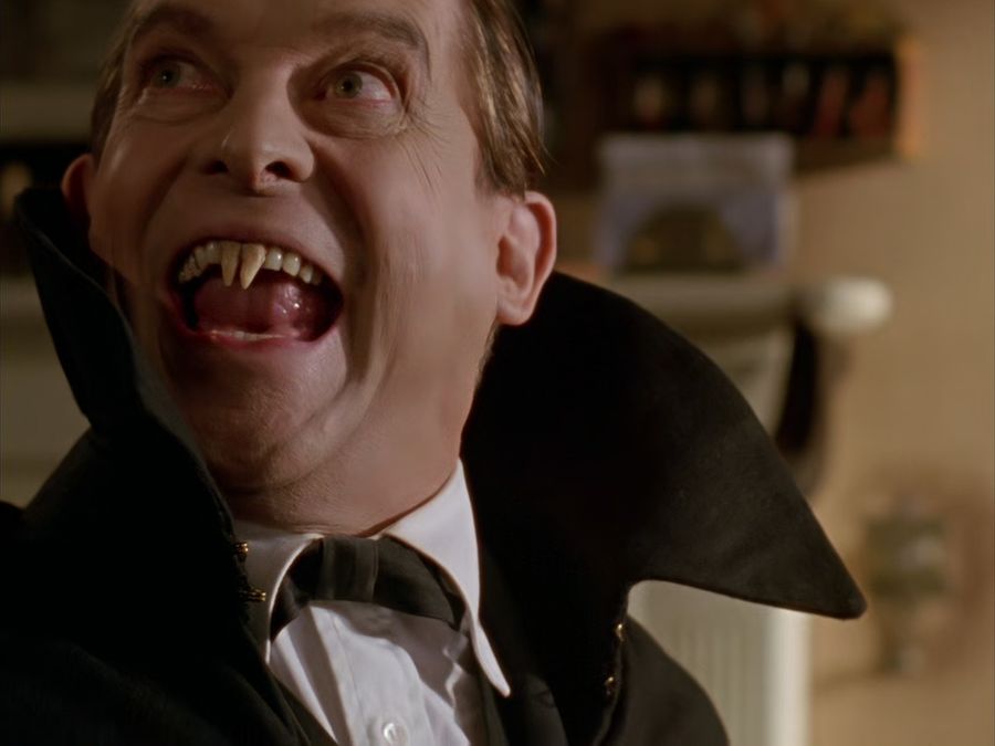 Sherlock Holmes with false vampire teeth