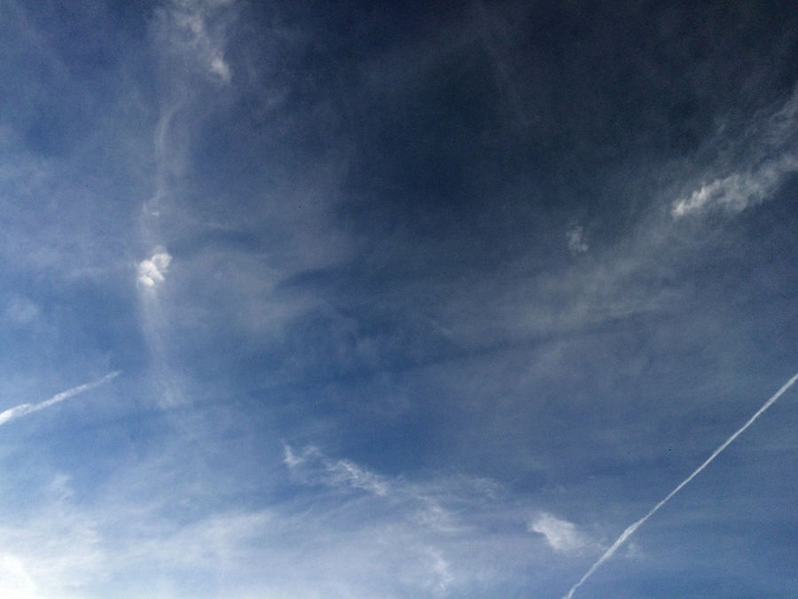 Wake turbulence trail that passes through the translucent haze of the cloud, forming the "empty" area and creates the illusion of a black band.

Excerpt: 1/533 sec

F-number: 2.2

ISO: 32

Flash: no flash
Translated by «Yandex.Translator»