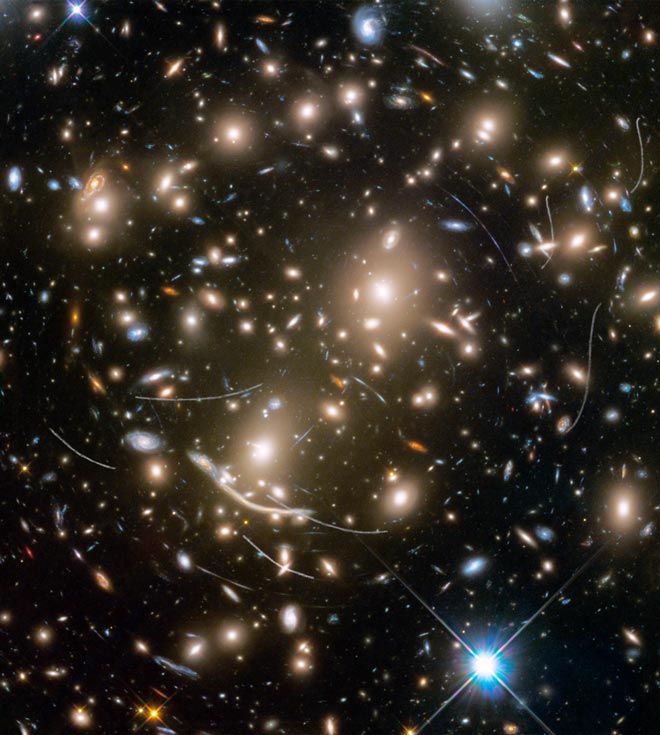 © NASA

This is a photograph of a parallel field of the galaxy cluster Abell 370. It was assembled from images taken in visible and infrared light. The field position on the sky close to the Ecliptic, the plane of our Solar system. This is an area where the majority of asteroids, which is why the astronomers of Hubble saw so many of them.
Translated by «Yandex.Translator»