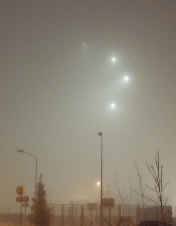 Lights from a construction site in the fog