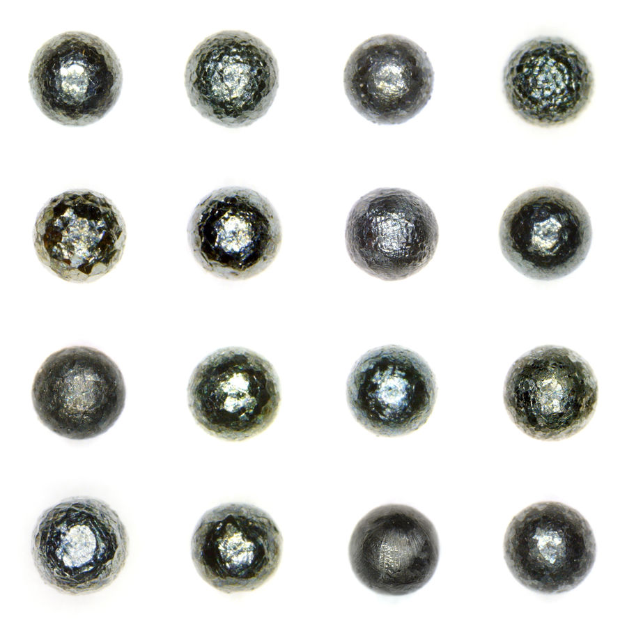 These "turtlenecks," photographed by John Larsen of the Stardust Project, are part of an ongoing study using typologies to differentiate micrometeorites from microscopic terrestrial globes.
Image courtesy of John Larsen, 2011