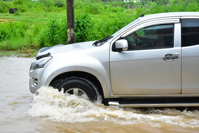 Car driving through monsoon rains
