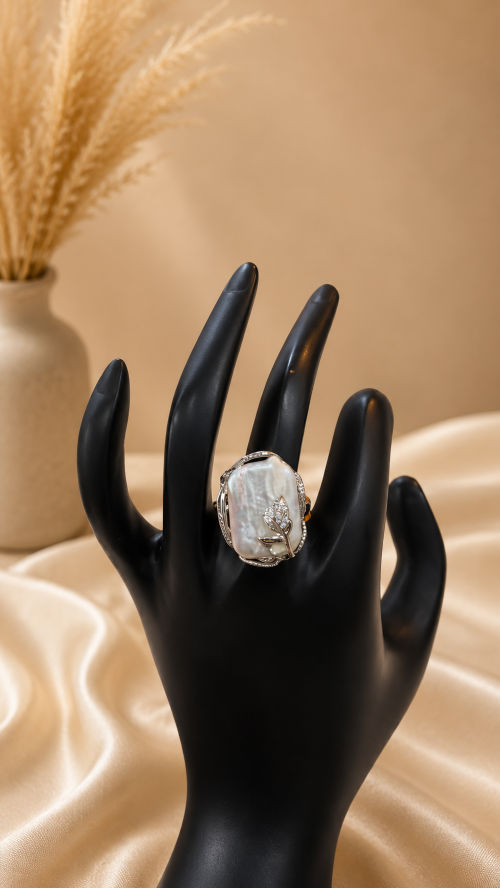 Mother of pearl, with intricate metal flower set in metal, statement ring