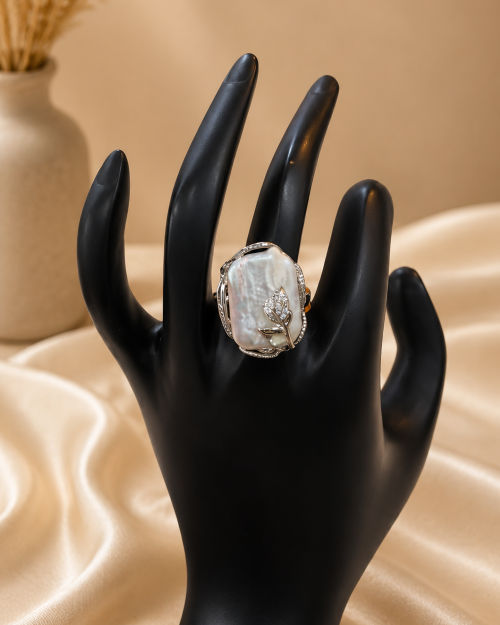 Mother of pearl, with intricate metal flower set in metal, statement ring