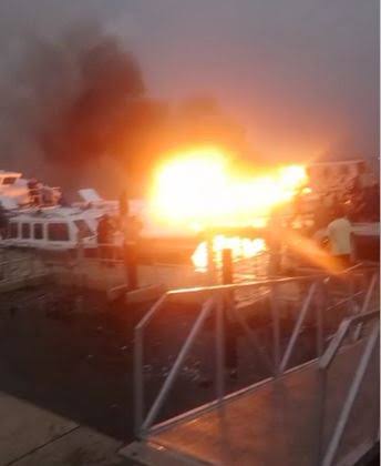 A Lagos ferry engulfed in flames at the Ipakodo Ferry Terminal in Ikorodu, with emergency responders evacuating passengers. Four individuals sustained severe injuries while 19 were rescued safely.